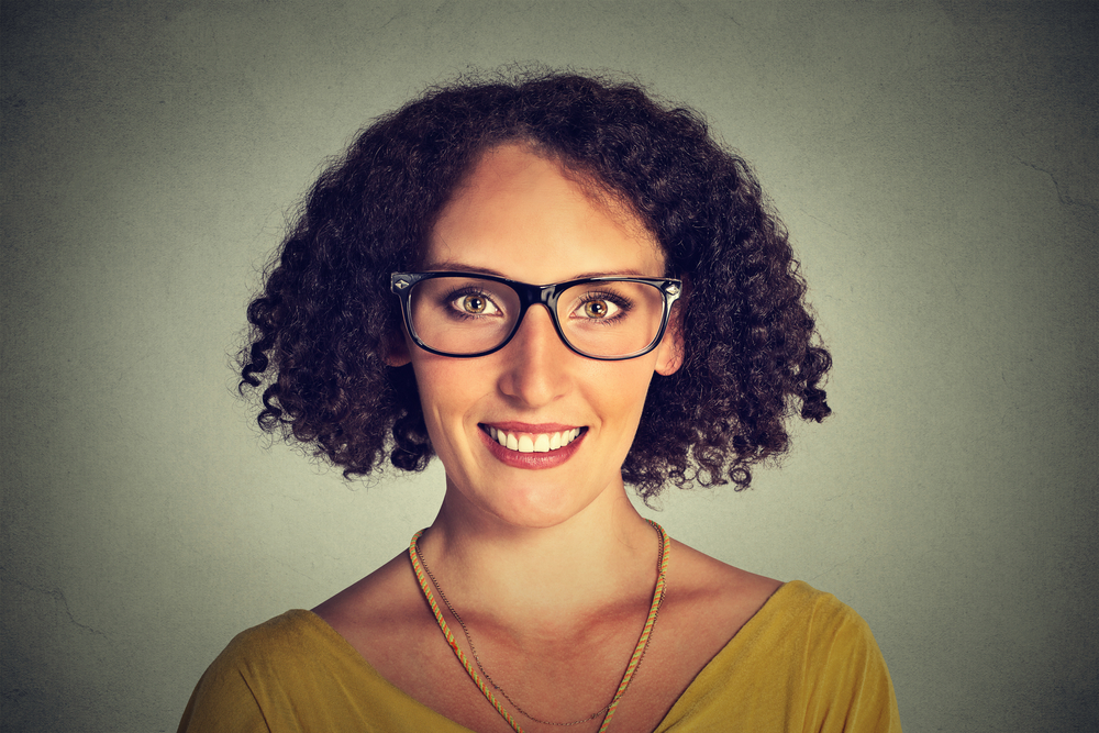 Happy young smiling woman in glasses