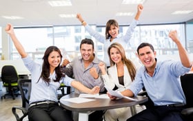 Successful business team with arms up at the office-1