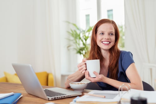 Thoughtful Young Woman Having her Breakfast at her Home Office, Showing Happy Facial Expression.-1