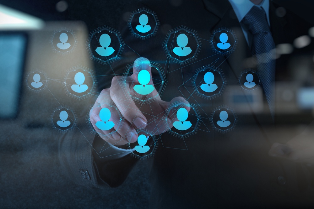 Double exposure of businessman hand points human resources, CRM and social media as concept.jpeg